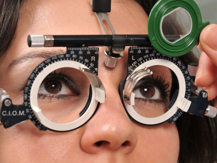 A woman getting her eyesight examined