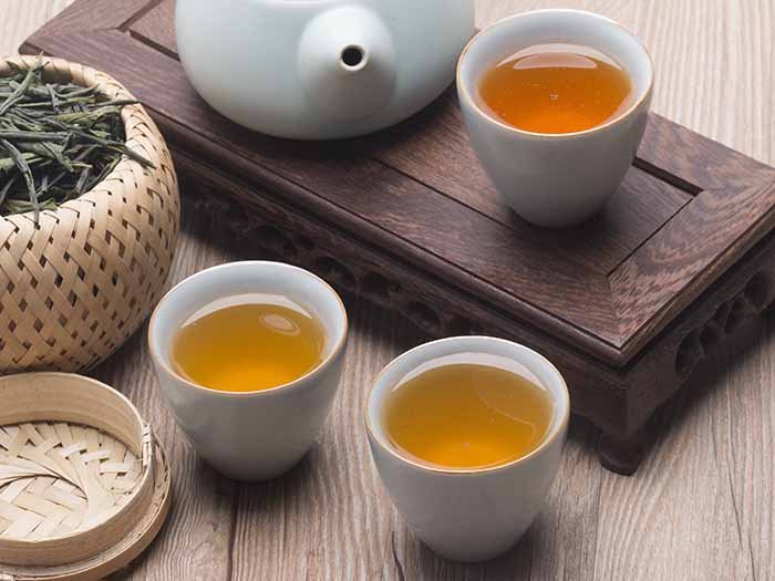 一套中国的茶壶和茶杯,装在篮子里的绿茶和茶叶