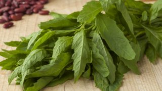 新鲜的未加工的绿色盖帽和扁豆特写镜头在一张木桌上