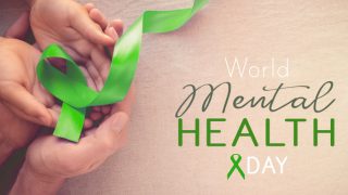 成人和儿童手持绿丝带,以提高心理健康意识