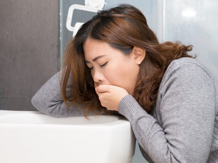 一个病容满面的女人,捂着嘴。