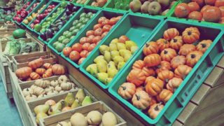 杂货店里装着不同蔬菜的一排排塑料托盘和篮子。