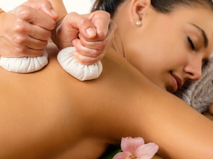 一个年轻女子得到一个精油按摩来缓解背部疼痛