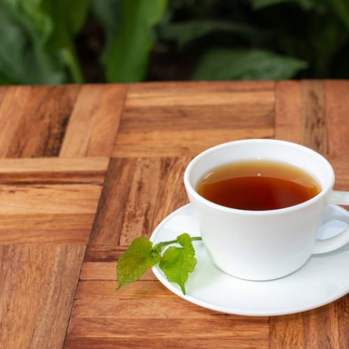 桑叶茶装在杯子里，放在木柜台上